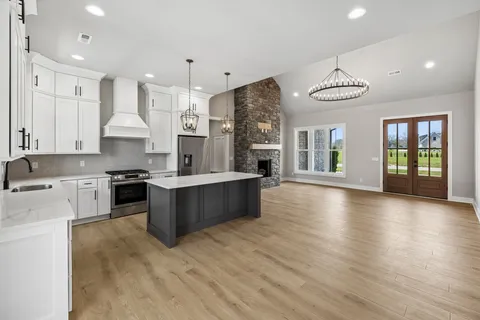 a large kitchen with stainless steel appliances granite countertop a large counter top and stove