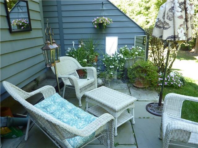 a couple of chairs sitting in front of a house