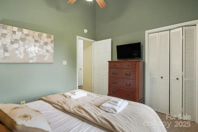 a bedroom with a bed and a television