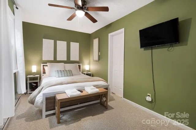 a bedroom with a bed and a flat screen tv