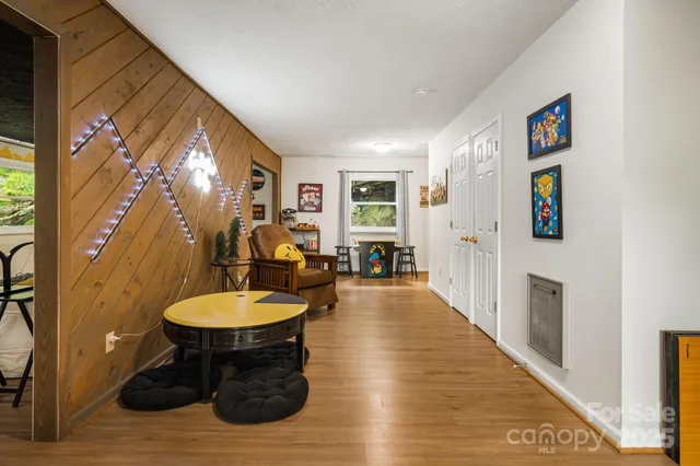 a living room with furniture and a wooden floor