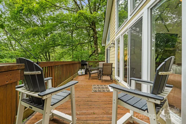 a view of a patio with table and chairs and wooden floor