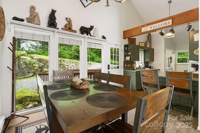 a dining room with furniture a chandelier and wooden floor