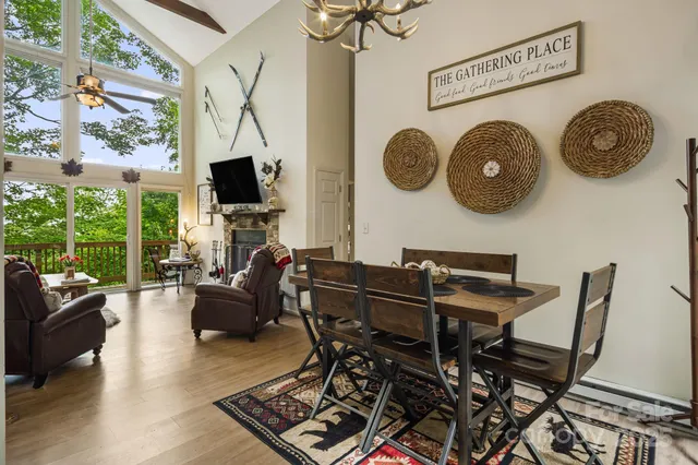 a living room with couches a fireplace with wooden floor