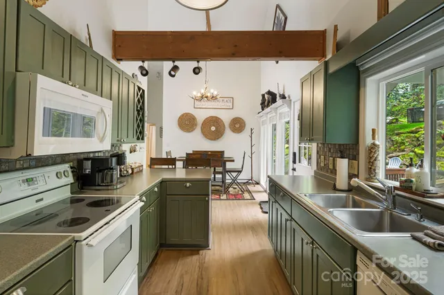 a kitchen that has a sink a stove and a wooden floor