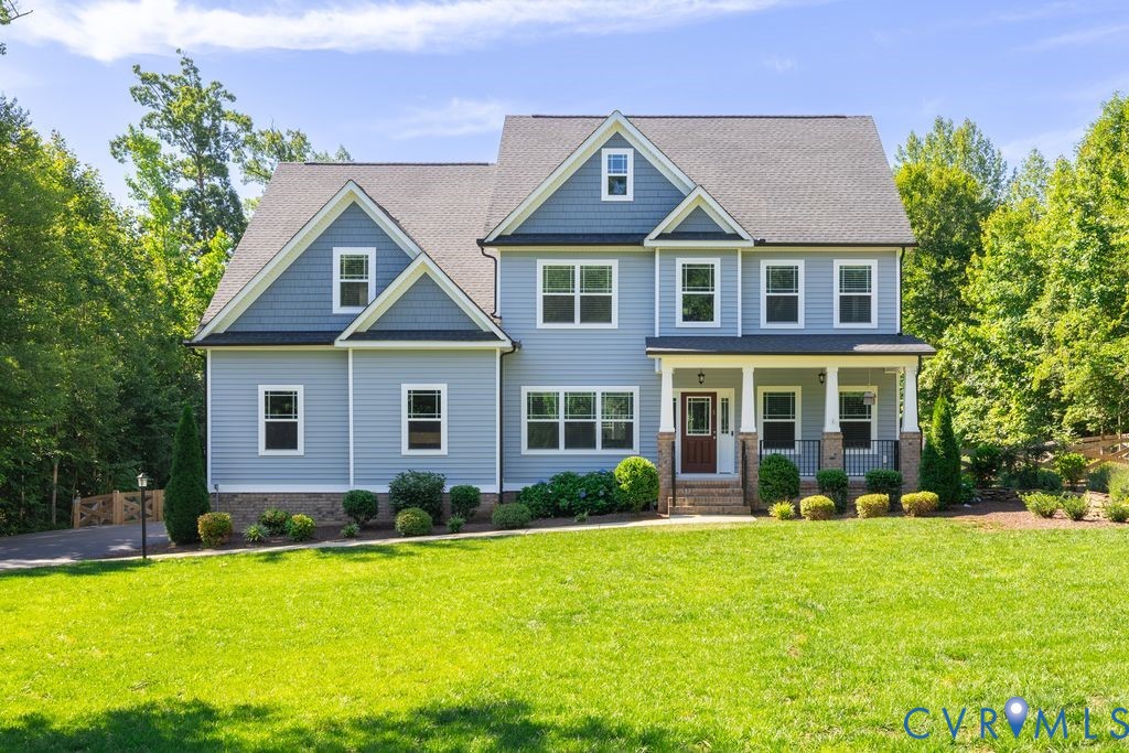 9377 Magnolia Blossom Road Ashland, VA 23005 - Photo 1 of 49 a front view of a house with garden