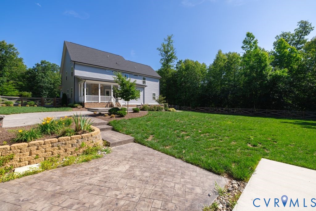 9377 Magnolia Blossom Road Ashland, VA 23005 - Photo 11 of 49 a front view of a house with garden