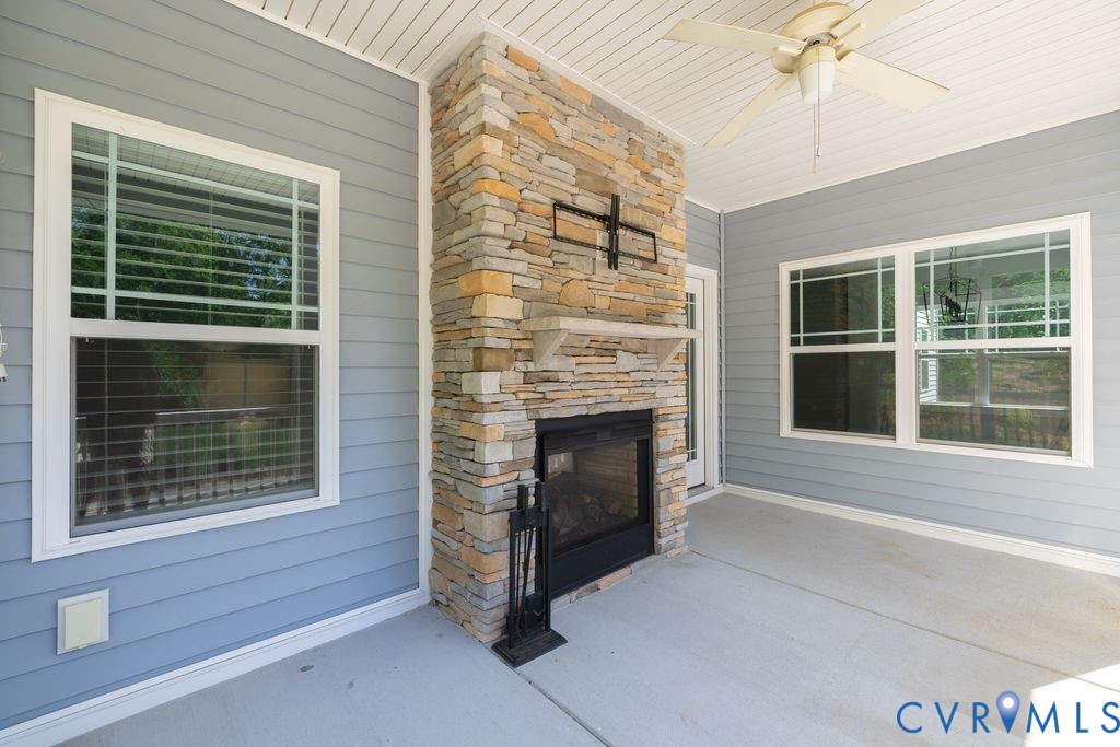 9377 Magnolia Blossom Road Ashland, VA 23005 - Photo 17 of 49 a living room with a fireplace and a large window