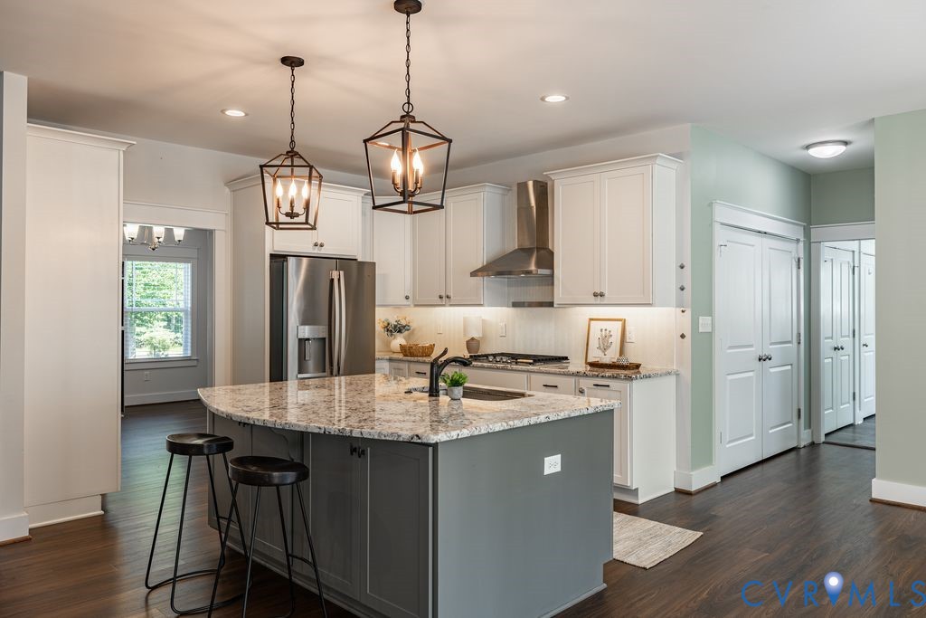 9377 Magnolia Blossom Road Ashland, VA 23005 - Photo 18 of 49 a kitchen with stainless steel appliances kitchen island a island in the center and wooden floor