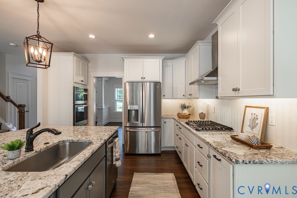 9377 Magnolia Blossom Road Ashland, VA 23005 - Photo 19 of 49 a kitchen with stainless steel appliances granite countertop a sink stove and refrigerator