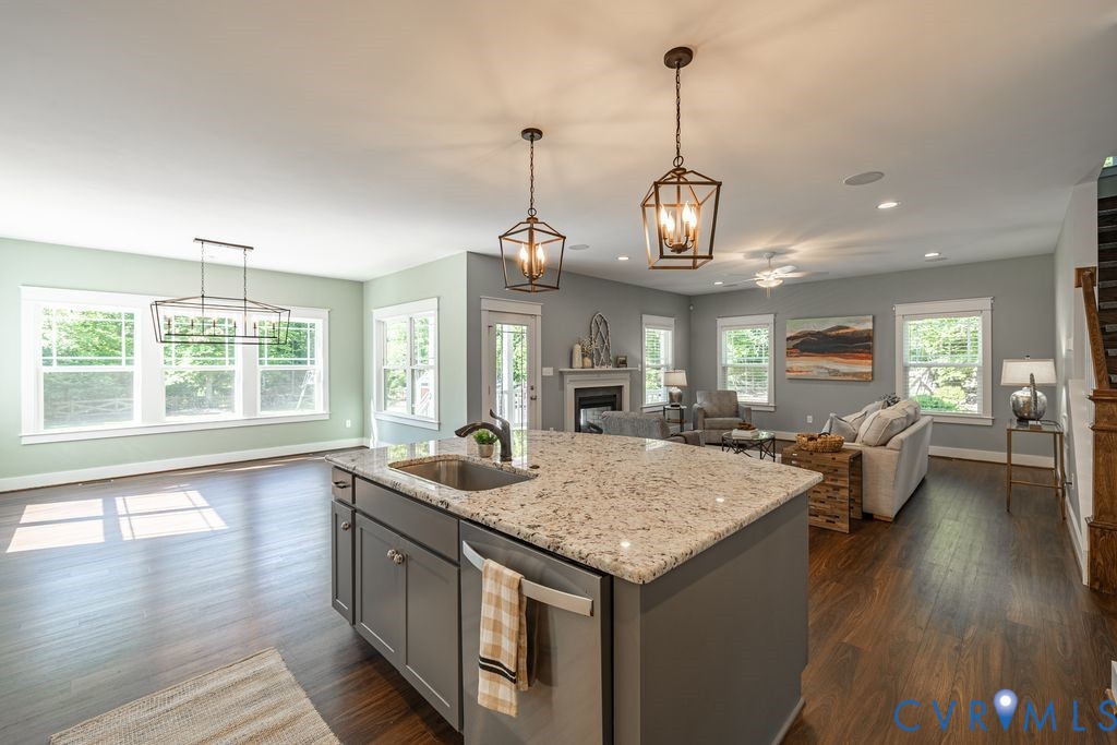 9377 Magnolia Blossom Road Ashland, VA 23005 - Photo 48 of 49 a kitchen with a stove center island and a wooden floor