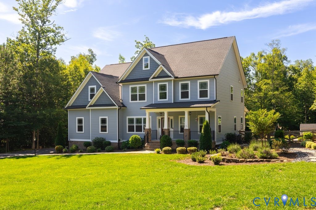 9377 Magnolia Blossom Road Ashland, VA 23005 - Photo 2 of 49 a front view of a house with a yard