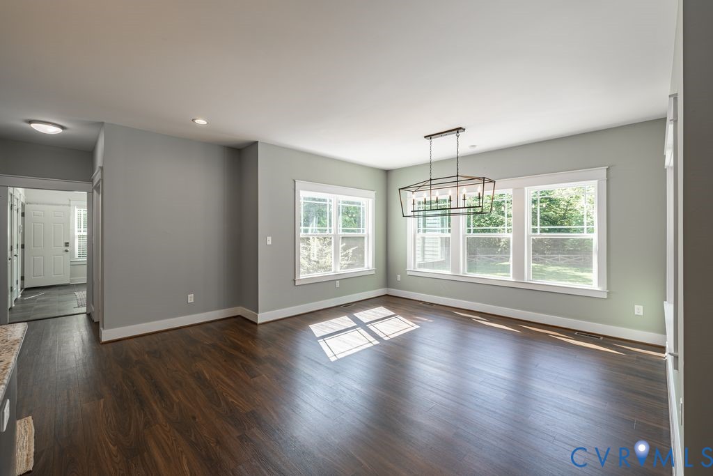 9377 Magnolia Blossom Road Ashland, VA 23005 - Photo 22 of 49 a view of an empty room with wooden floor and a window
