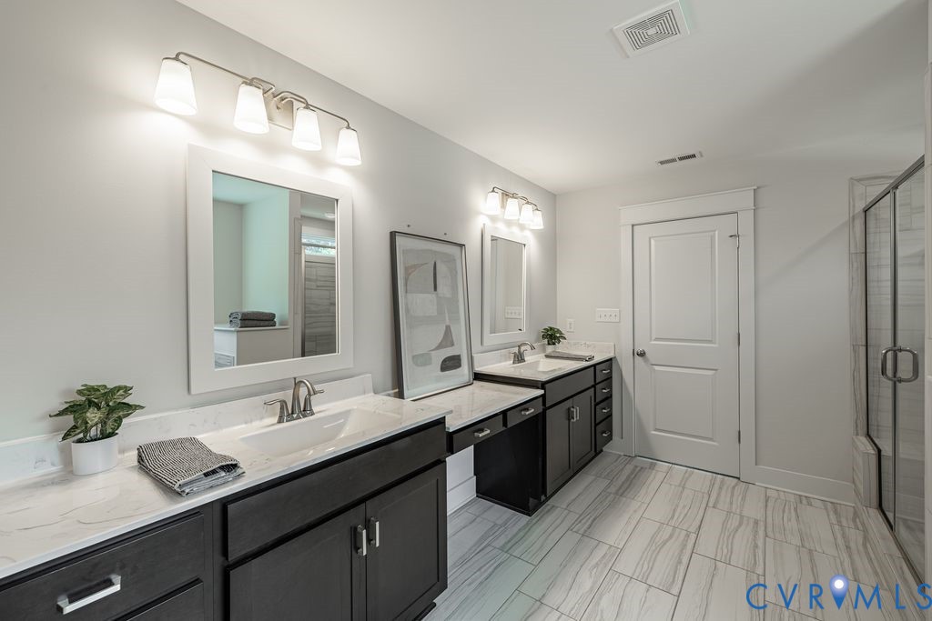 9377 Magnolia Blossom Road Ashland, VA 23005 - Photo 34 of 49 a spacious bathroom with a granite countertop sink and a mirror