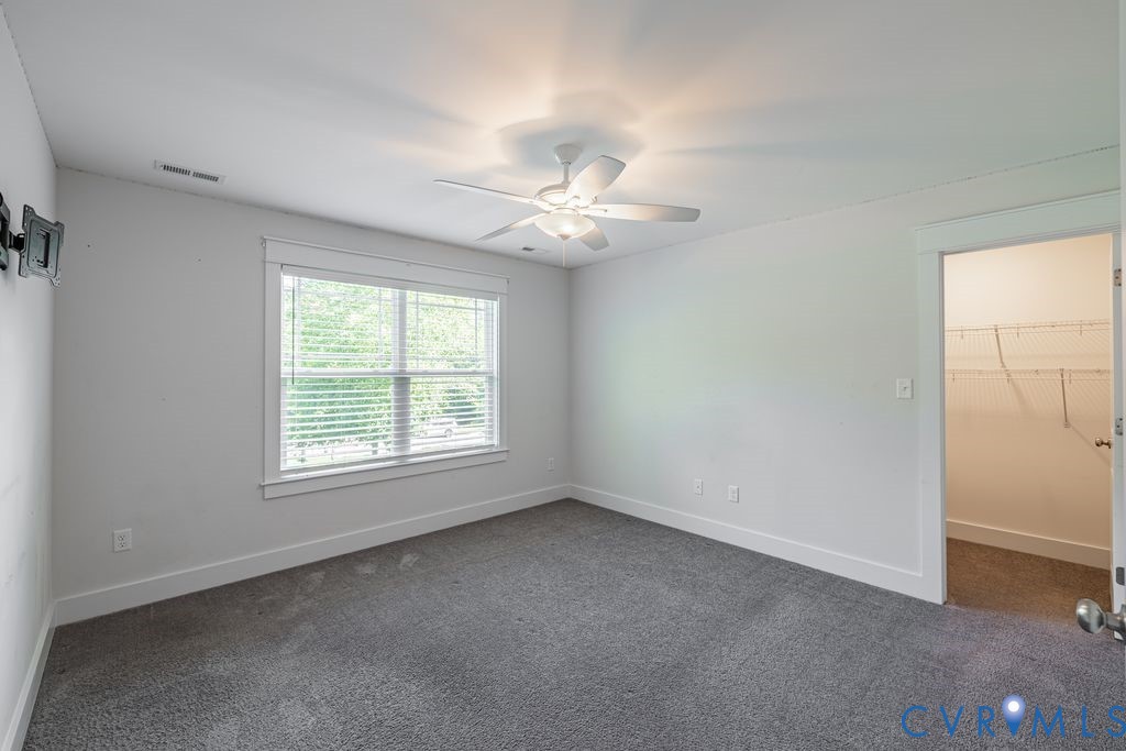 9377 Magnolia Blossom Road Ashland, VA 23005 - Photo 38 of 49 an empty room with a window and a ceiling fan