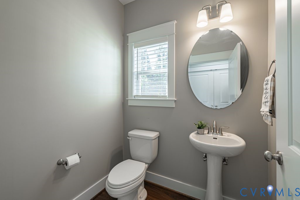 9377 Magnolia Blossom Road Ashland, VA 23005 - Photo 43 of 49 a bathroom with a toilet sink and mirror