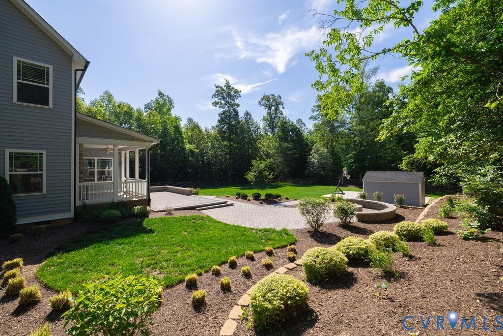 9377 Magnolia Blossom Road Ashland, VA 23005 - Photo 8 of 49 a view of backyard with a garden and plants