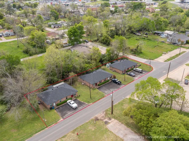 an aerial view of a house with a yard