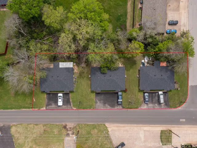 an aerial view of a house with a yard