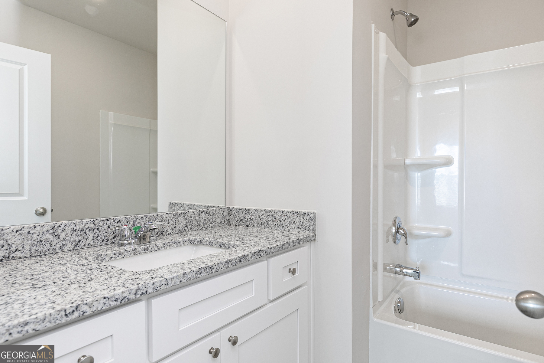 241 Rooker Drive LaGrange, GA 30241 - Photo 14 of 15 a bathroom with a granite countertop sink and a mirror