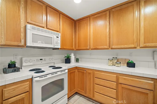a kitchen with stainless steel appliances granite countertop a sink a stove and cabinets