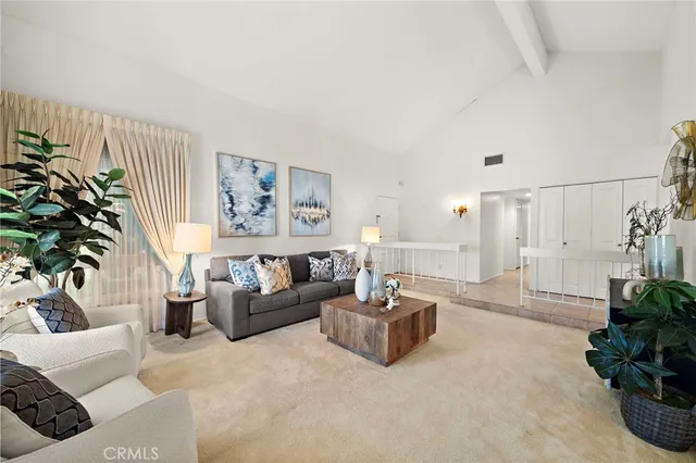 a living room with furniture and a potted plant