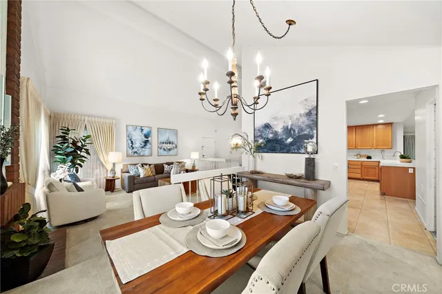 a view of a dining room with furniture a chandelier and wooden floor