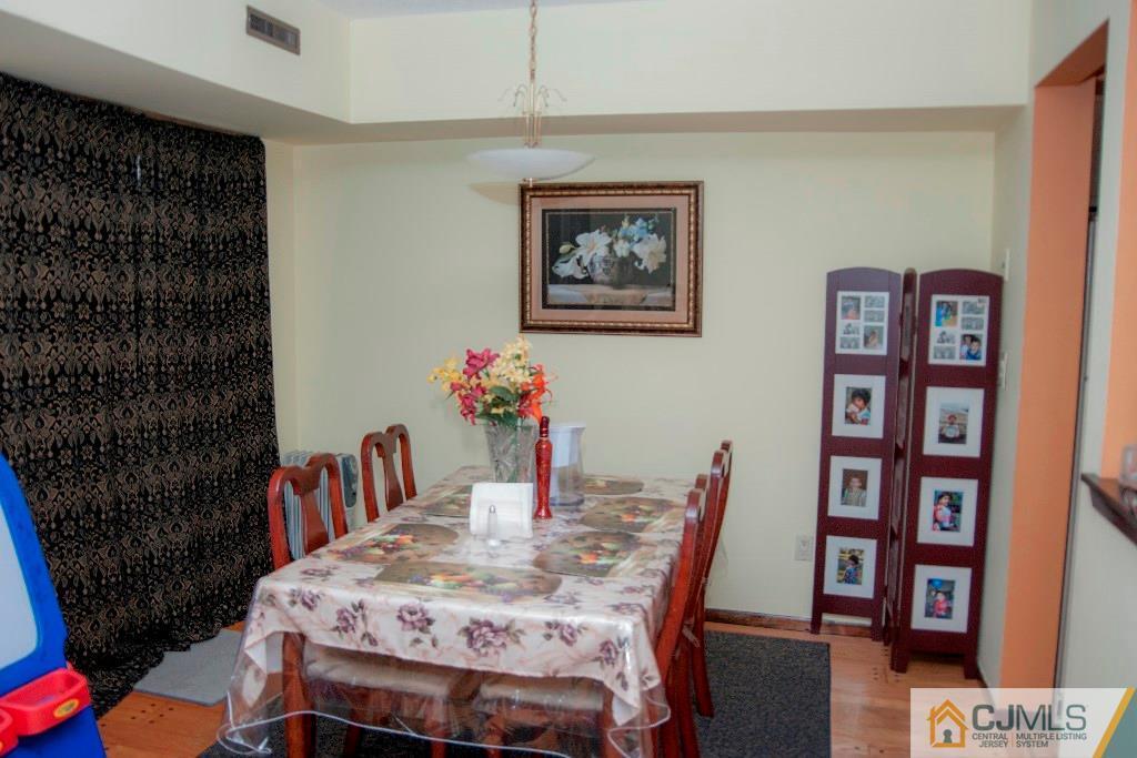 5802 Hana Road Edison, NJ 08817 - Photo 6 of 17 a view of a dining room with furniture and chandelier