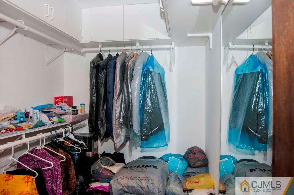 5802 Hana Road Edison, NJ 08817 - Photo 10 of 17 a view of walk in closet with clothes and shoes