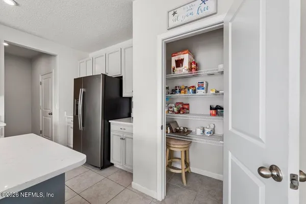 a kitchen with stainless steel appliances a refrigerator and a stove top oven