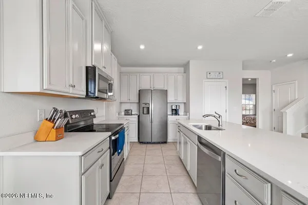 a kitchen with a sink a stove and a refrigerator
