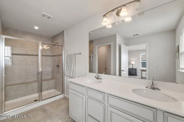 a bathroom with a glass shower door
