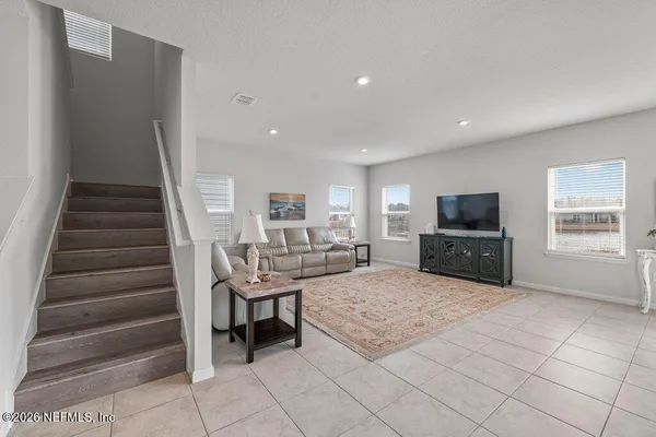 a view of a livingroom with furniture and a kitchen