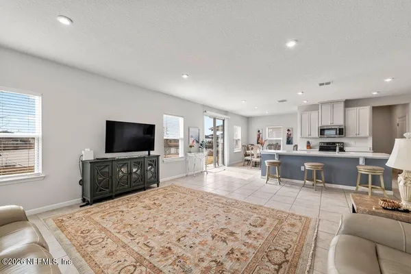 a view of a livingroom with furniture and a flat screen tv