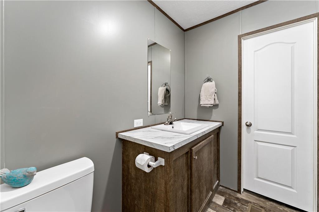 48 Brookhaven Avenue Washington, PA 15301 - Photo 15 of 35 a bathroom with a granite countertop sink a toilet and a mirror