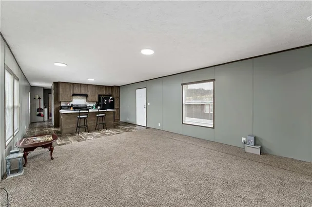 a view of a livingroom with workspace and a window