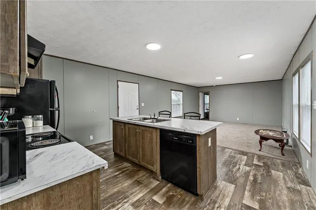 a kitchen with a sink appliances and cabinets