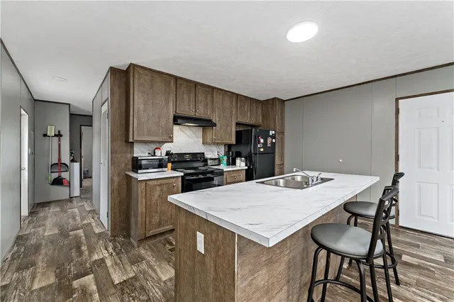 a kitchen with a table chairs refrigerator and cabinets