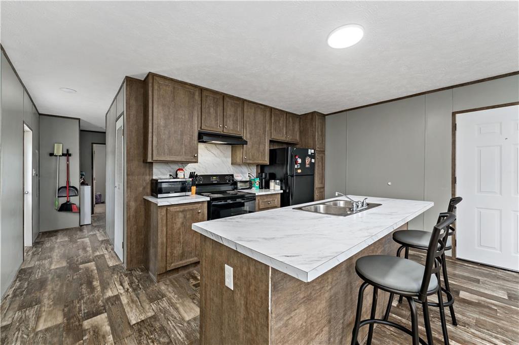 48 Brookhaven Avenue Washington, PA 15301 - Photo 9 of 35 a kitchen with a table chairs refrigerator and cabinets