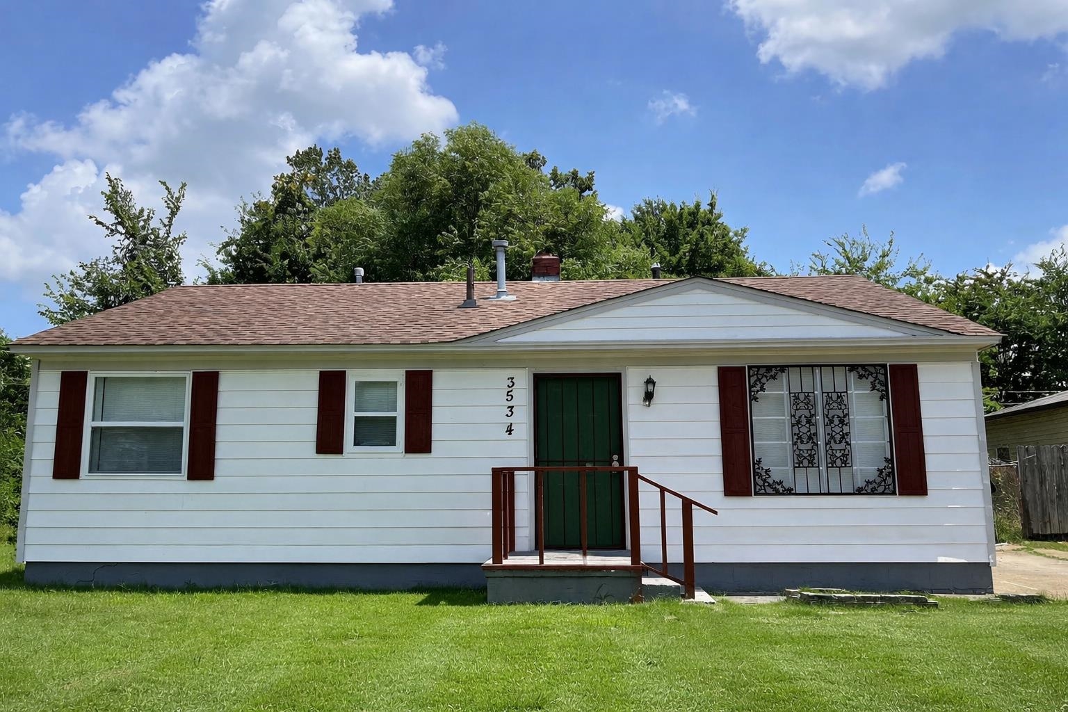 Ranch-style home with a front yard and a shingled roof