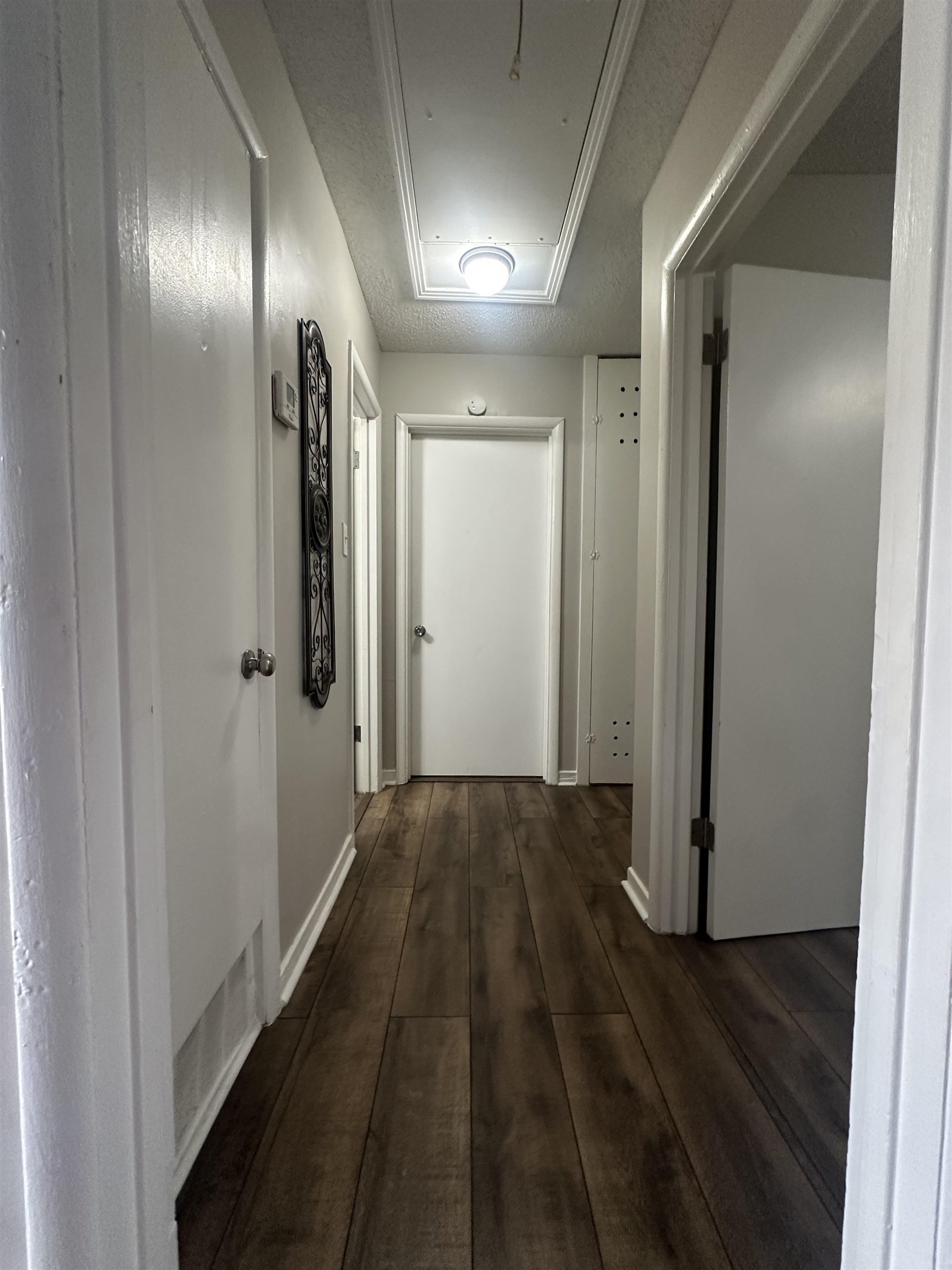 3534 Rochester Road Memphis, TN 38109 - Photo 11 of 13 Hallway featuring attic access and dark wood-type flooring