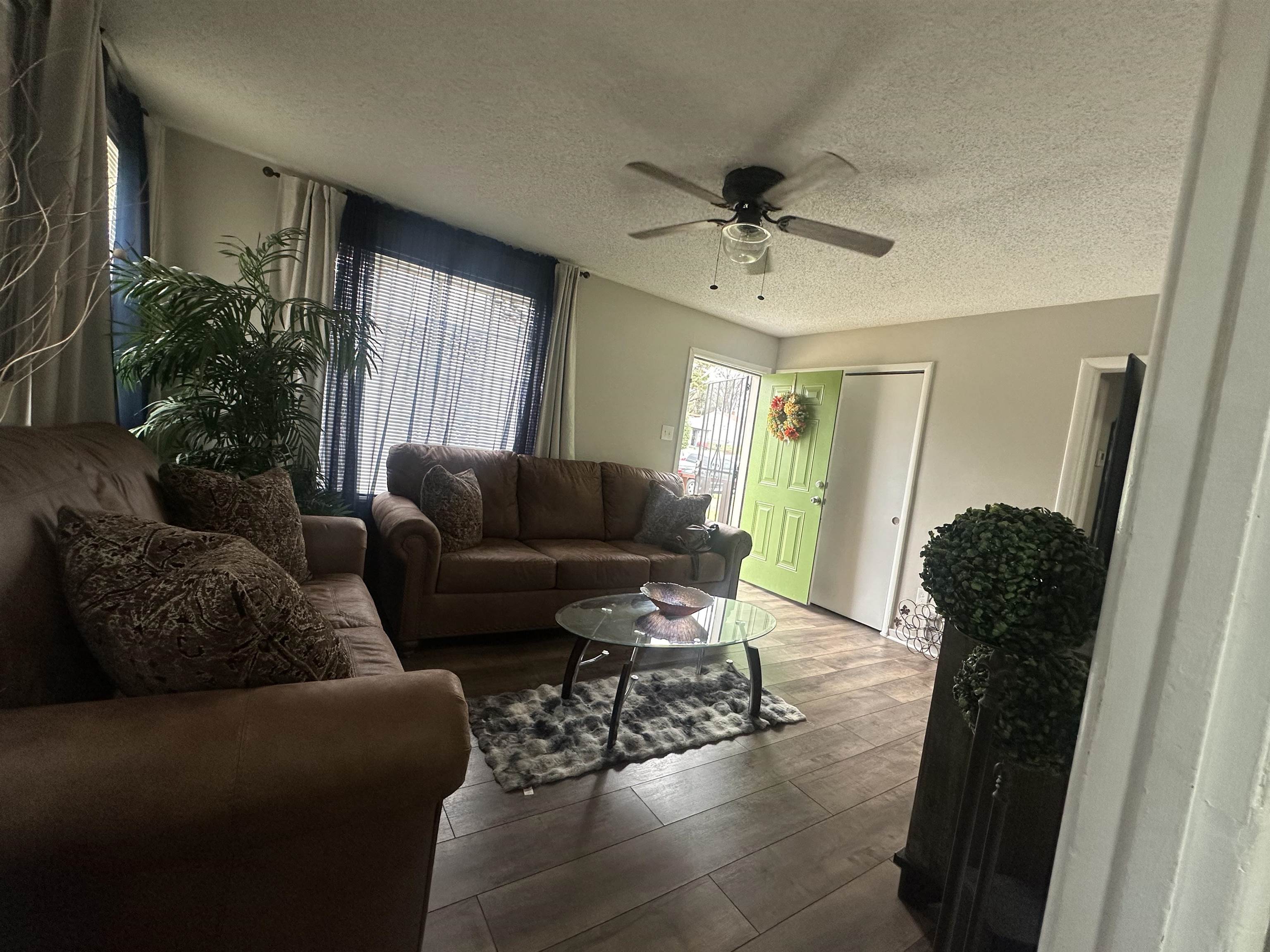 3534 Rochester Road Memphis, TN 38109 - Photo 4 of 13 Living area featuring a textured ceiling, wood-type flooring, and a ceiling fan