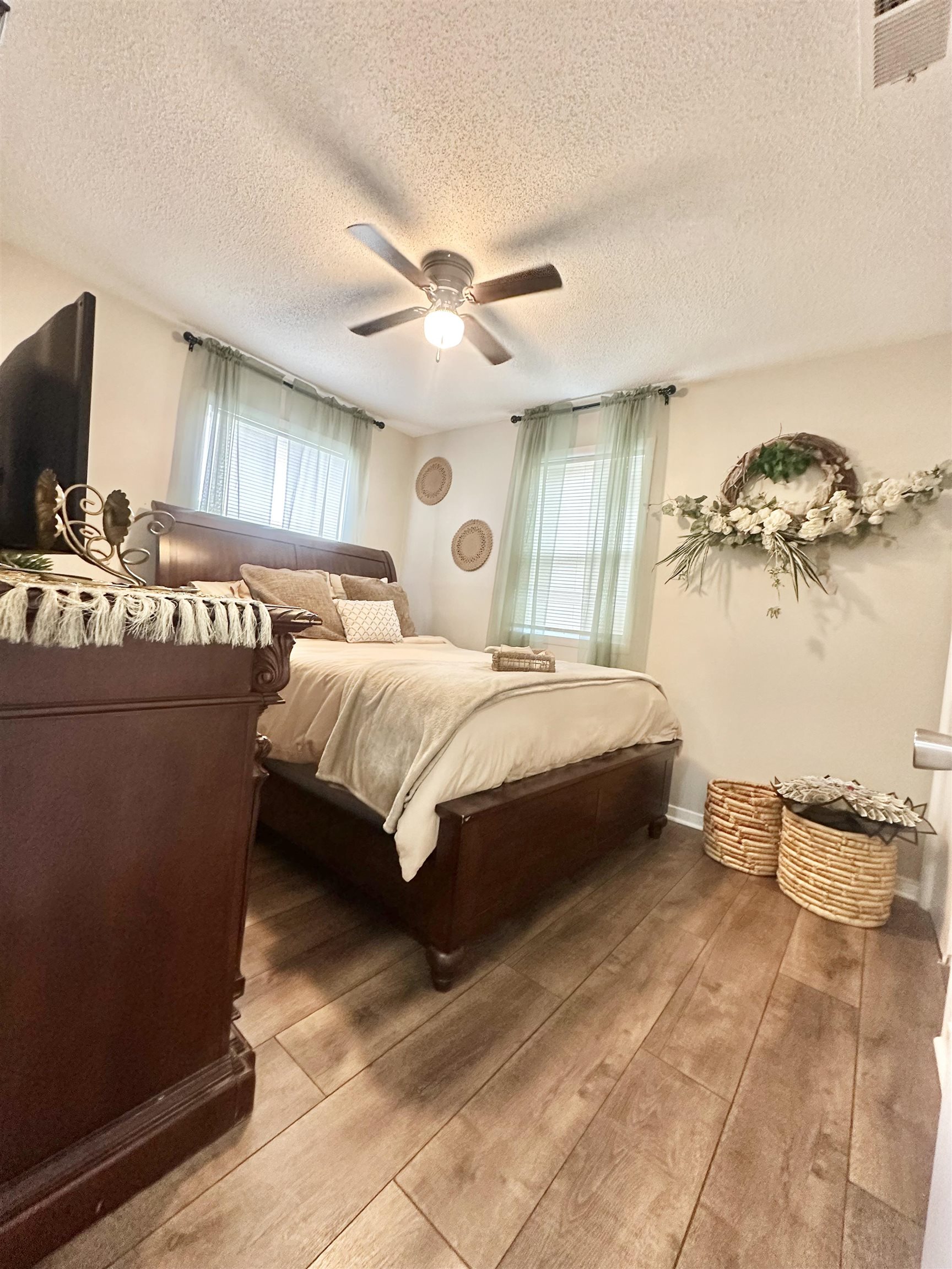 3534 Rochester Road Memphis, TN 38109 - Photo 7 of 13 Bedroom with wood-type flooring, a ceiling fan, and a textured ceiling