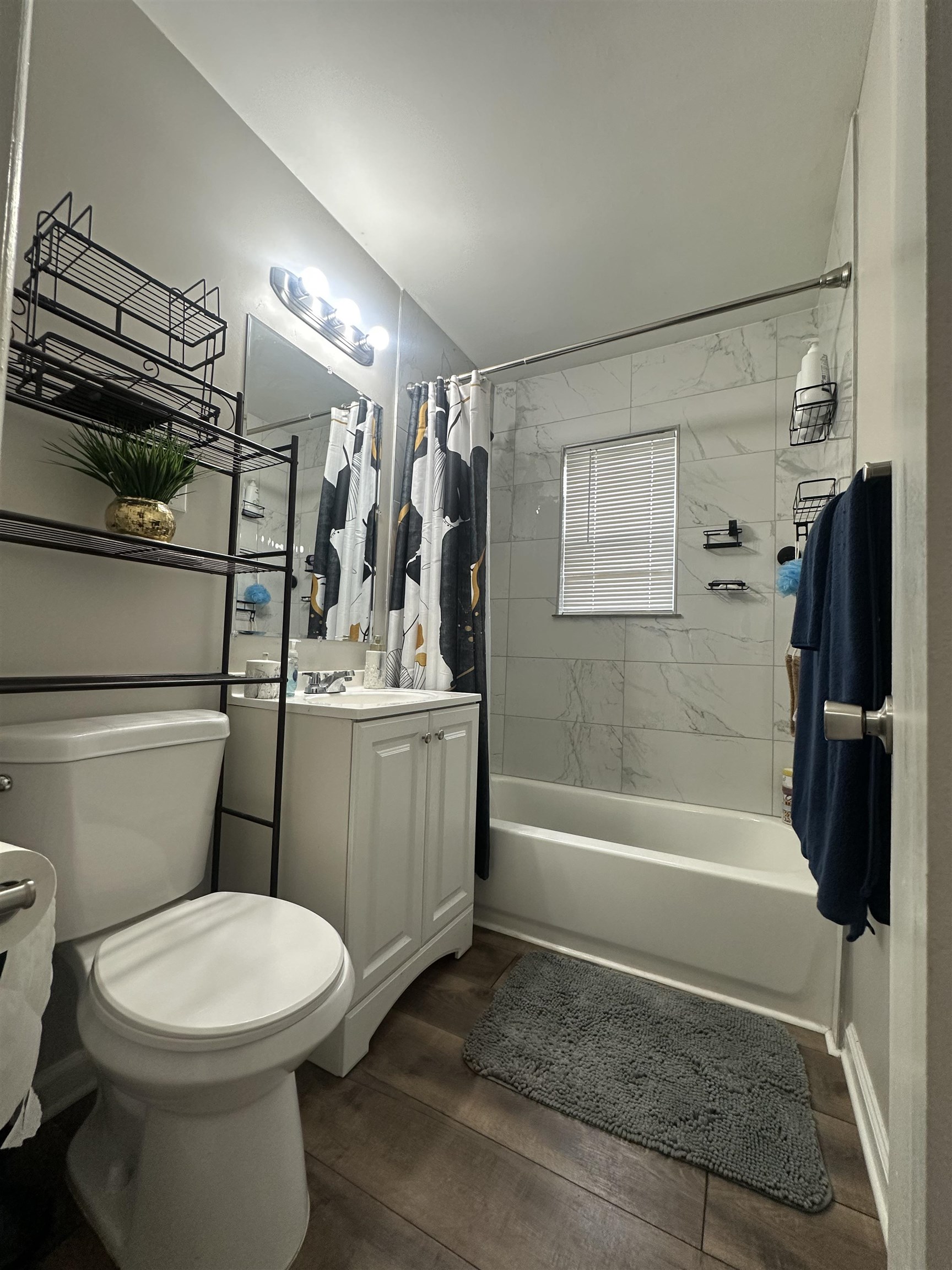 3534 Rochester Road Memphis, TN 38109 - Photo 9 of 13 Bathroom with vanity, shower / tub combo with curtain, and dark wood-style floors