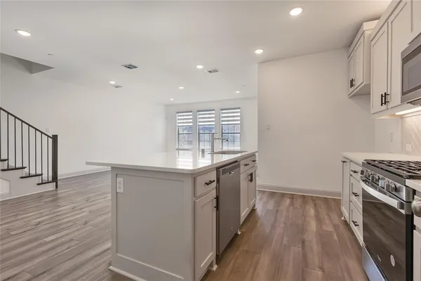 a kitchen with granite countertop a stove and a sink