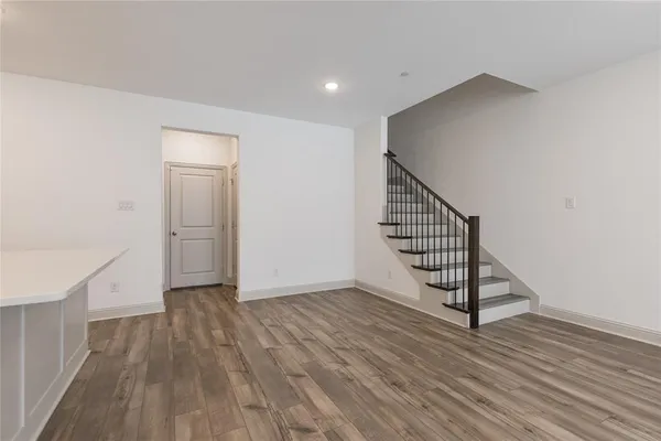 a view of a hallway with wooden floor and staircase
