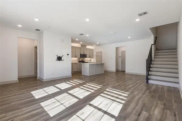 a view of kitchen with cabinets and wooden floor