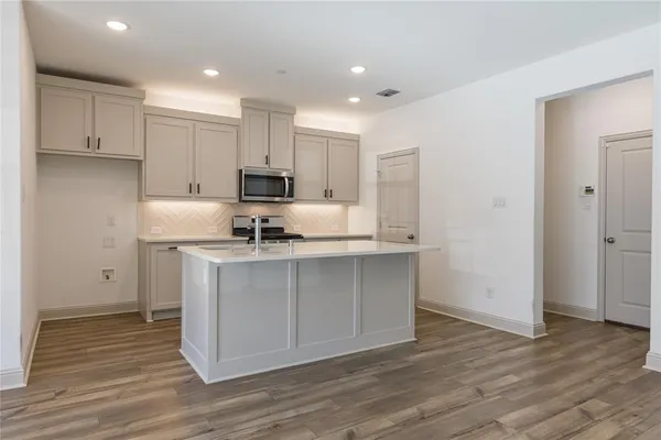 a kitchen with granite countertop a sink and cabinets