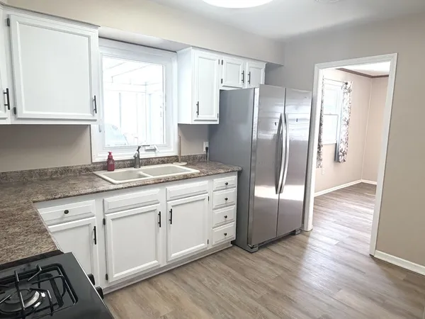 a kitchen with stainless steel appliances granite countertop a refrigerator sink and cabinets