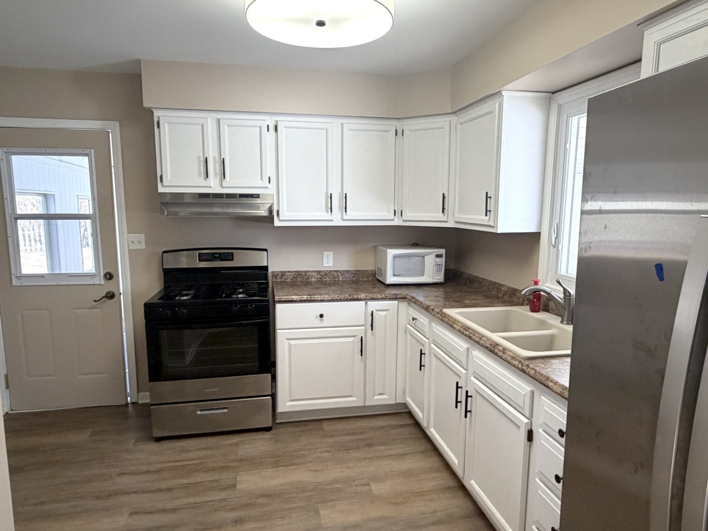 2007 Schuyler Drive Peru, IL 61354 - Photo 4 of 13 a kitchen with stainless steel appliances granite countertop a refrigerator and a stove top oven
